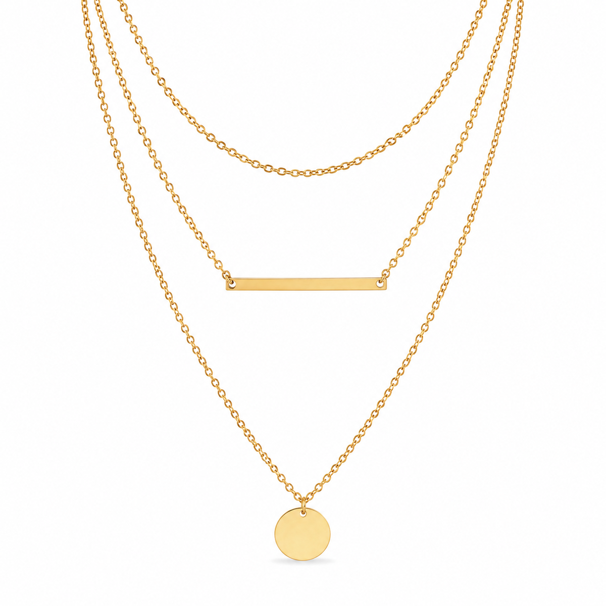 Triple layer gold necklace with short cable chain, bar pendant, and coin pendant on white background